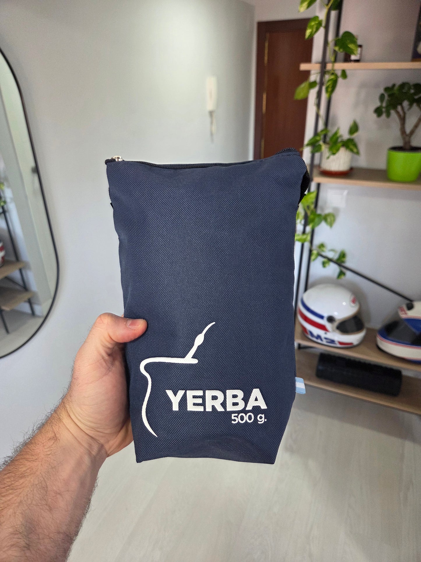 Yerbero de tela de 500g azul visto de frente, con logo impreso y cierre de cremallera en la parte superior.