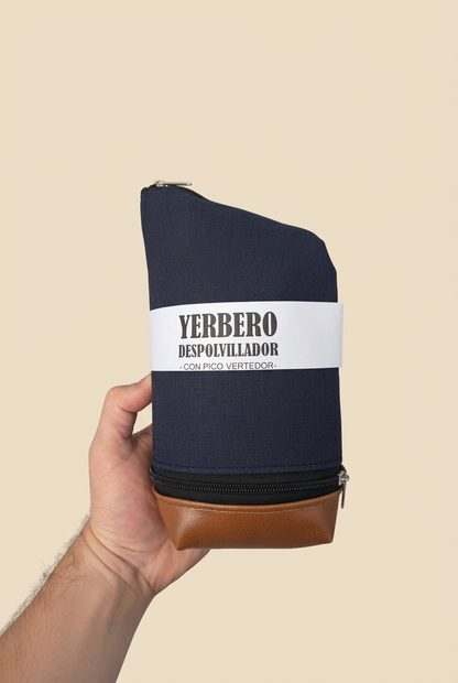 Yerbero Quita Polvo azul sostenido en una mano sobre fondo beige